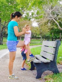 mom with a baby training in the park